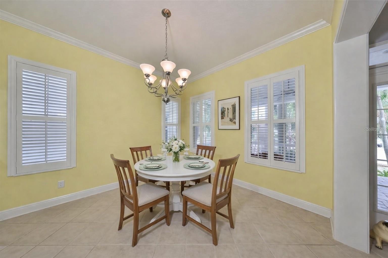 Dining room or formal living room adorned with windows.