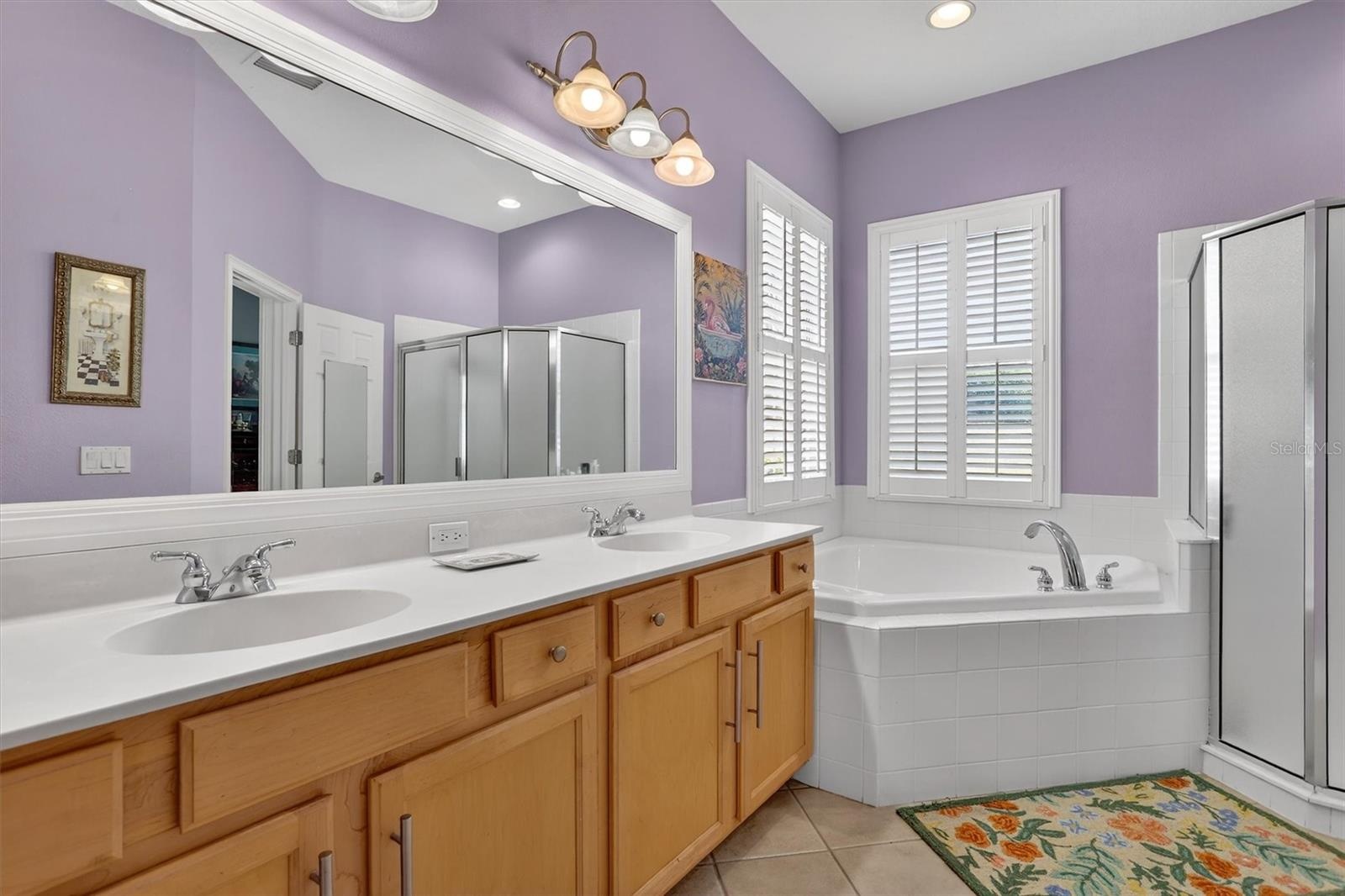 Primary bath with separate large soaking tub and double vanity.