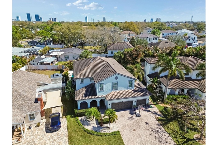 Tropical landscaping and palms highlight the home’s striking curb appeal. Near Downtown.