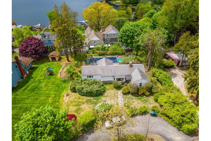 Ranch home with circular driveway, pool and deeded lake rights
