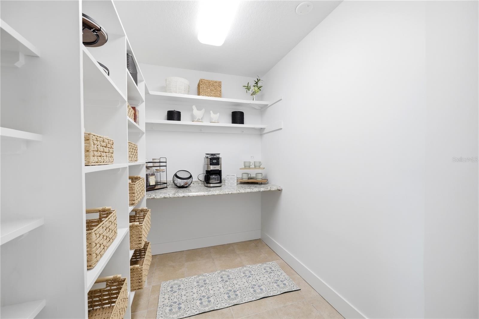 oversized walk in pantry with built in granite counter