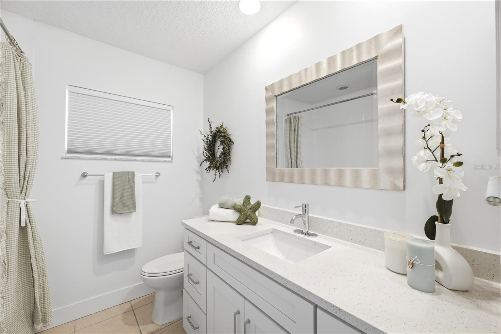 updated full guest full bathroom shared with back hall bedrooms
