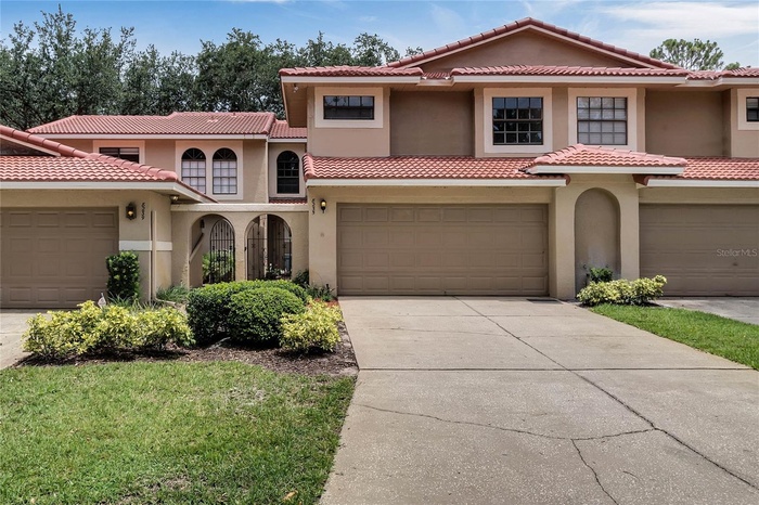 Front elevation with two-car garage and private courtyard entry