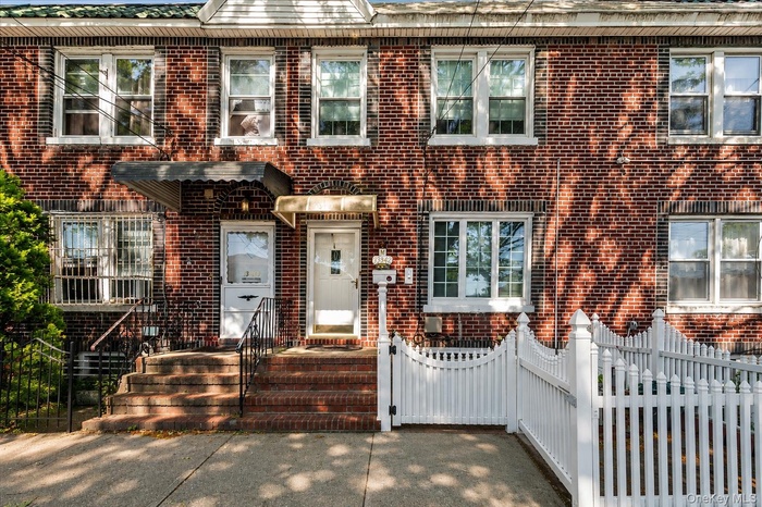 Brick facade townhome featuring multiple windows