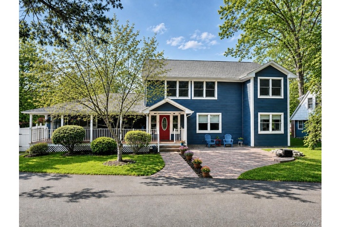 Welcome to the main house with a wonderful rocking chair front porch and expansive driveway that fits 5 cars!