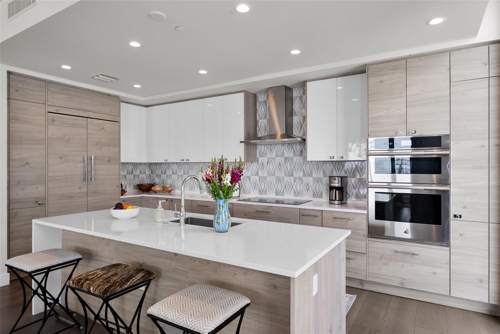 Designer backsplash, kitchen cabinet/drawer pulls, hardwood flooring included in many upgraded features.