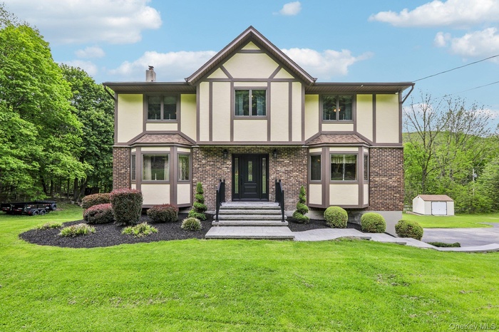 Tudor Style Colonial home situated on 1.0 acres of park like property.