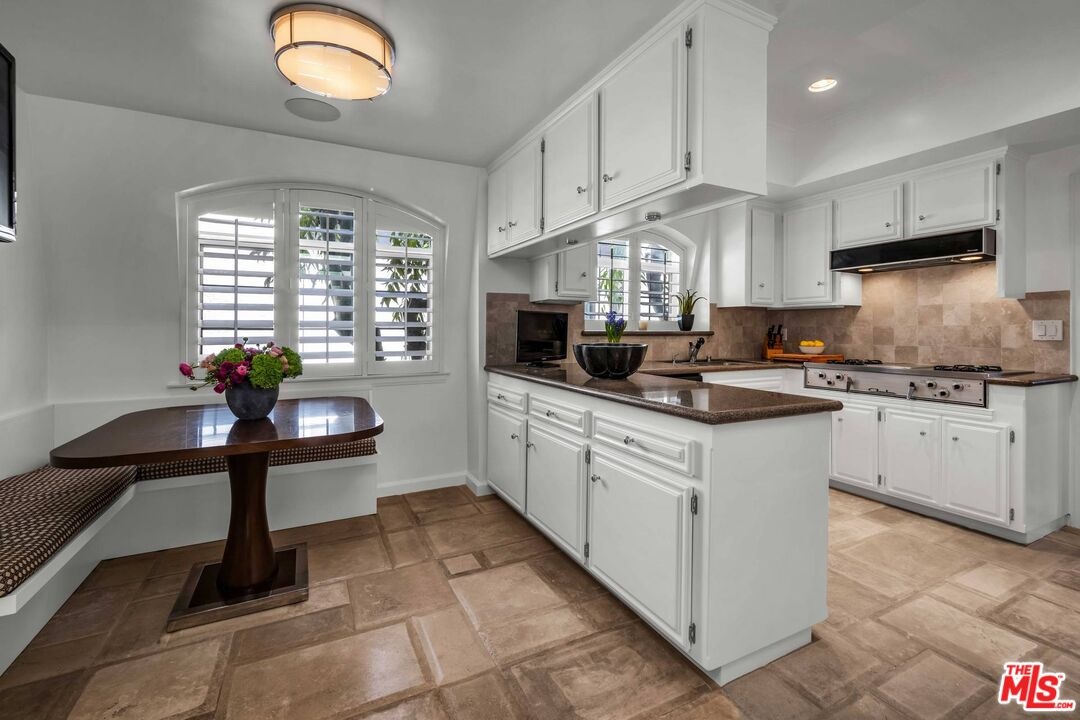 Kitchen with white cabinetry,