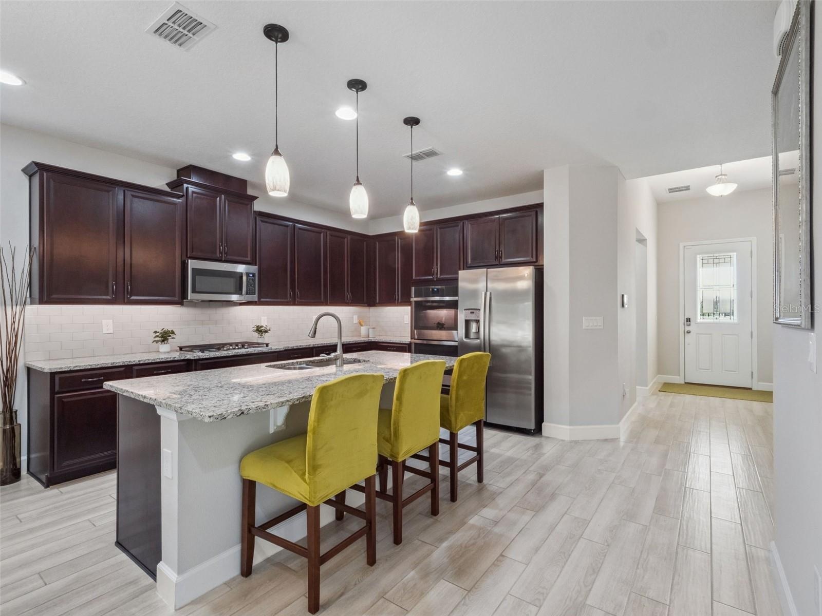 Kitchen towards foyer + bedroom 1
