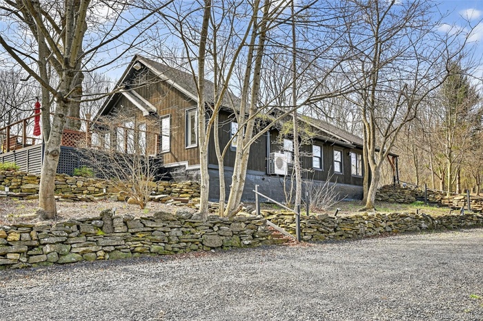 Wood-sided exterior featuring multiple windows and a gabled roofline