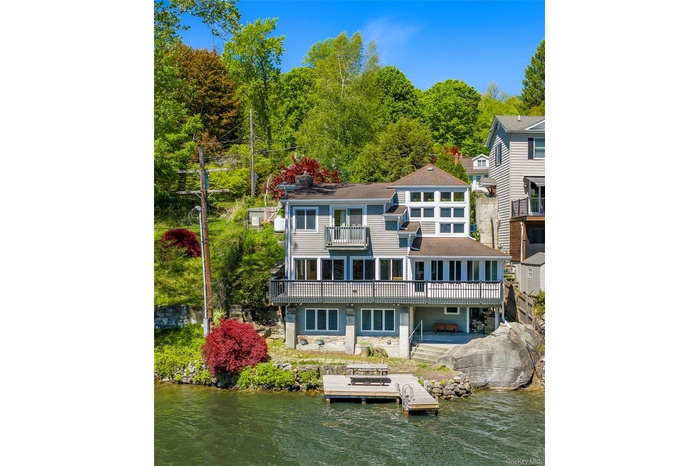Lakefront property with private dock and adjoining protected land that preserves exceptional privacy and open space.