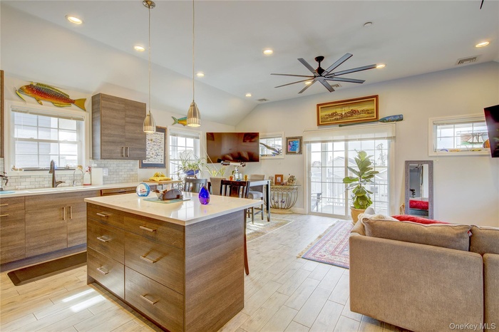 Kitchen with a center island, open floor plan, recessed lighting, healthy amount of natural light, and tasteful backsplash