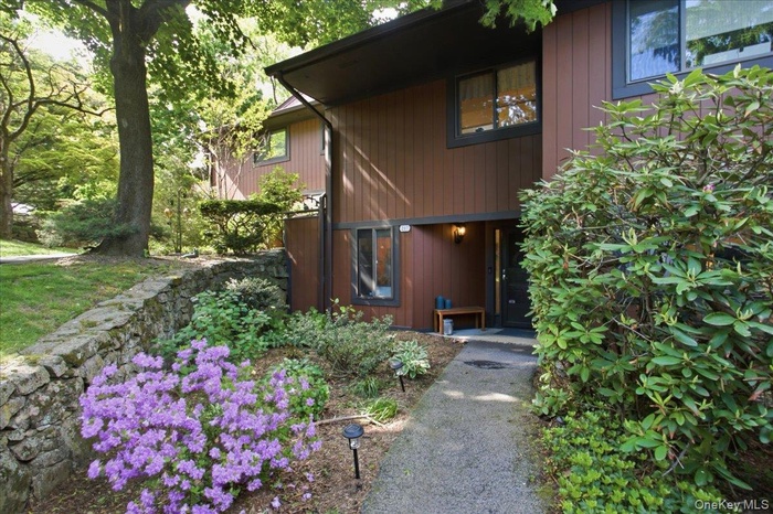 Welcome home to contemporary living in Tarrytown, where lush meandering paths and wooded surroundings create a retreat-like setting just moments from 