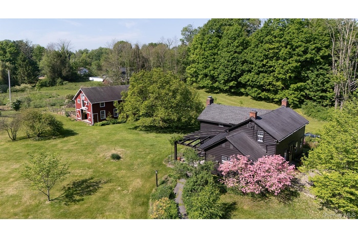 Expansive property featuring the vintage farmhouse and barn