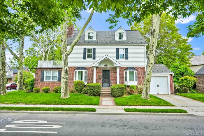 Traditional  Gross Morton Model residence featuring white siding and brick veneer