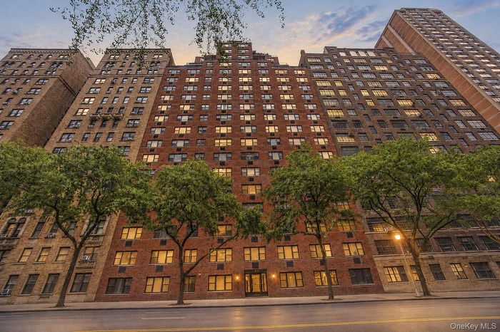 Multi-story brick facade building featuring a stepped architectural design
