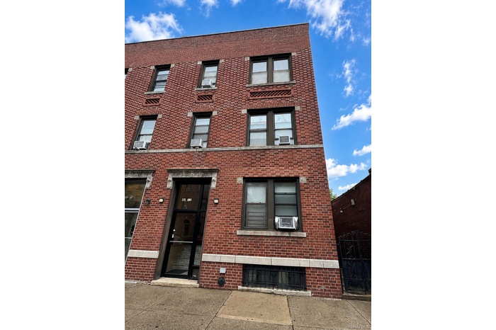 Brick facade building featuring multiple large windows