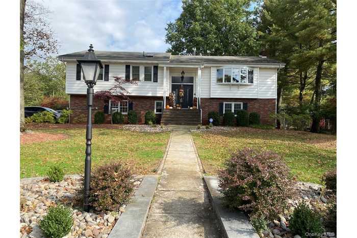 Raised ranch featuring a front lawn