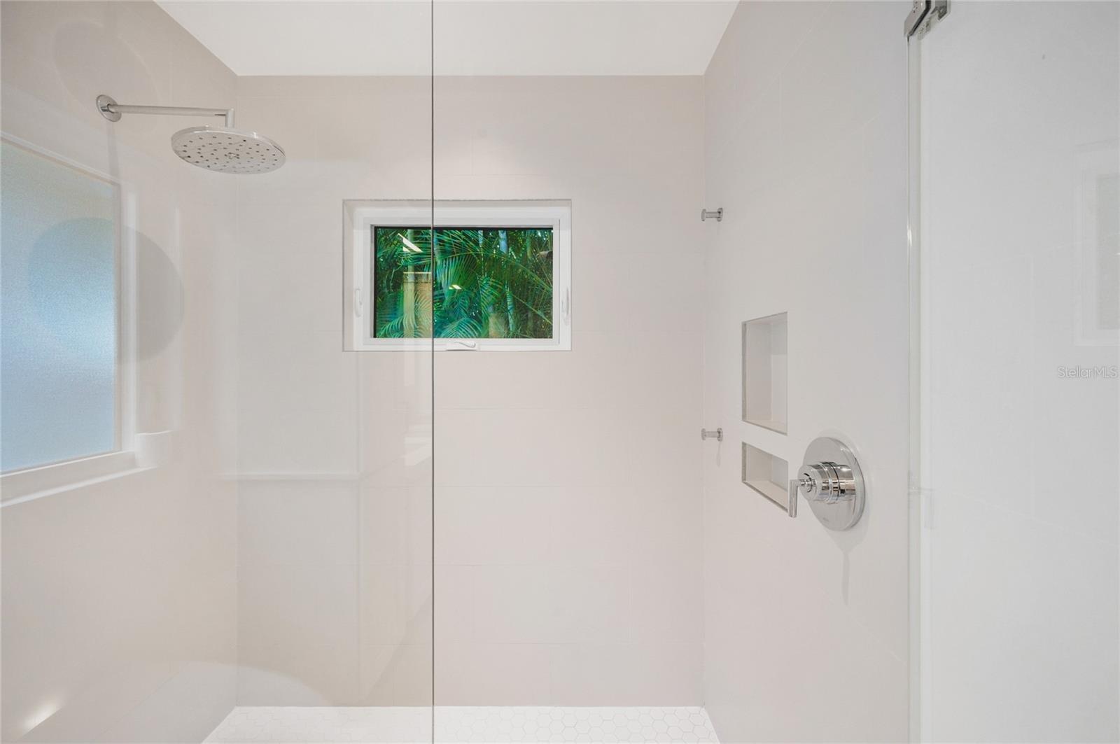 Primary bathroom with a tropical view
