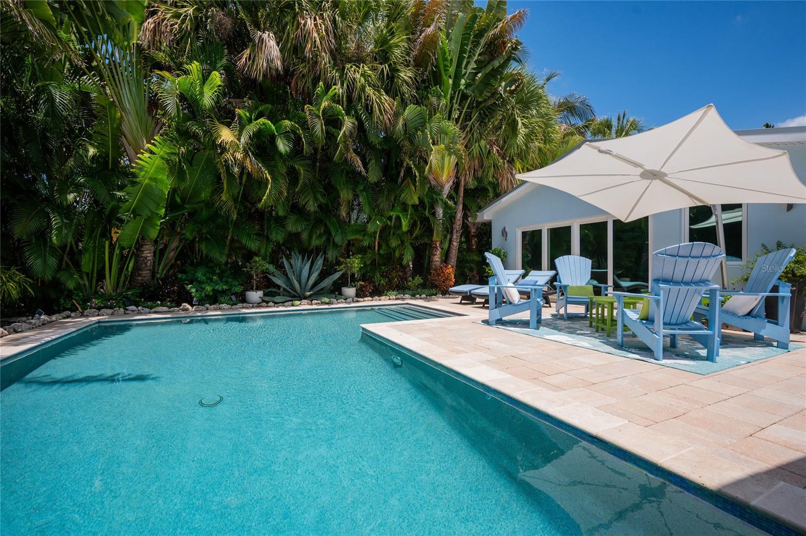 Imagine taking a dip in this refreshing pool in this private tropical oasis