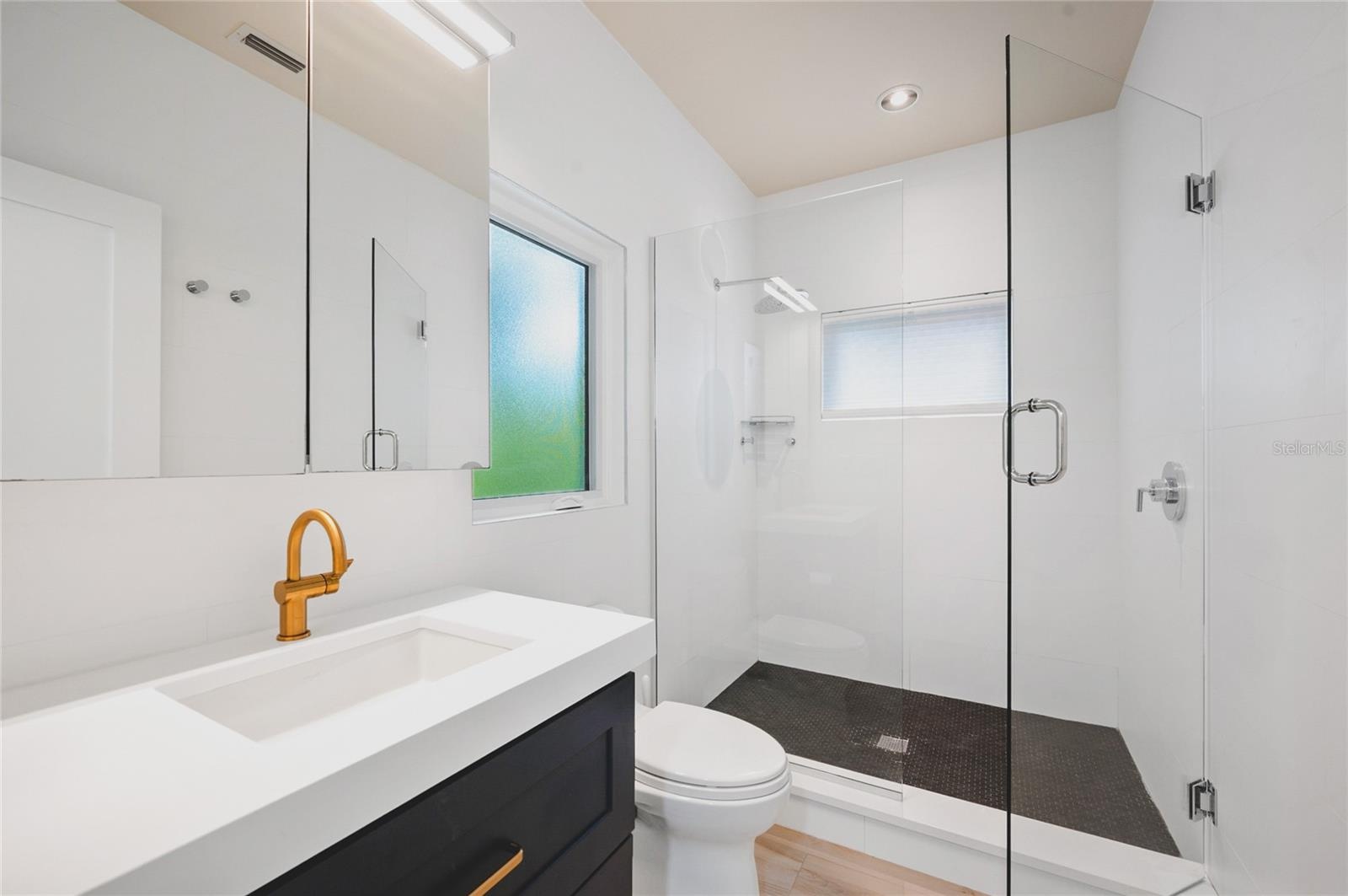 Guest ensuite bathroom (2nd bathroom) with custom cabinetry and fixtures