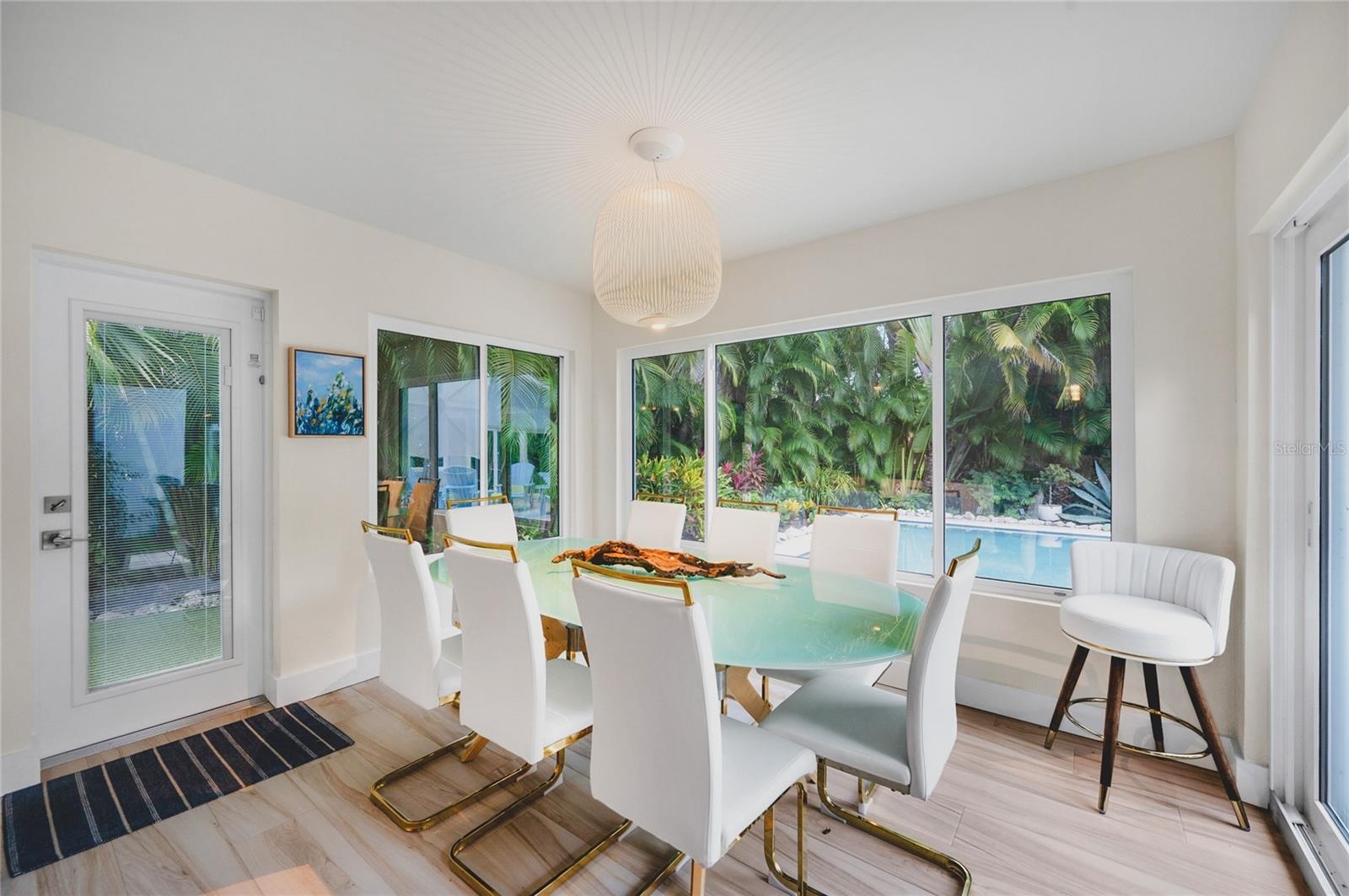 Dining area with seating for 8 and a view of the pool area