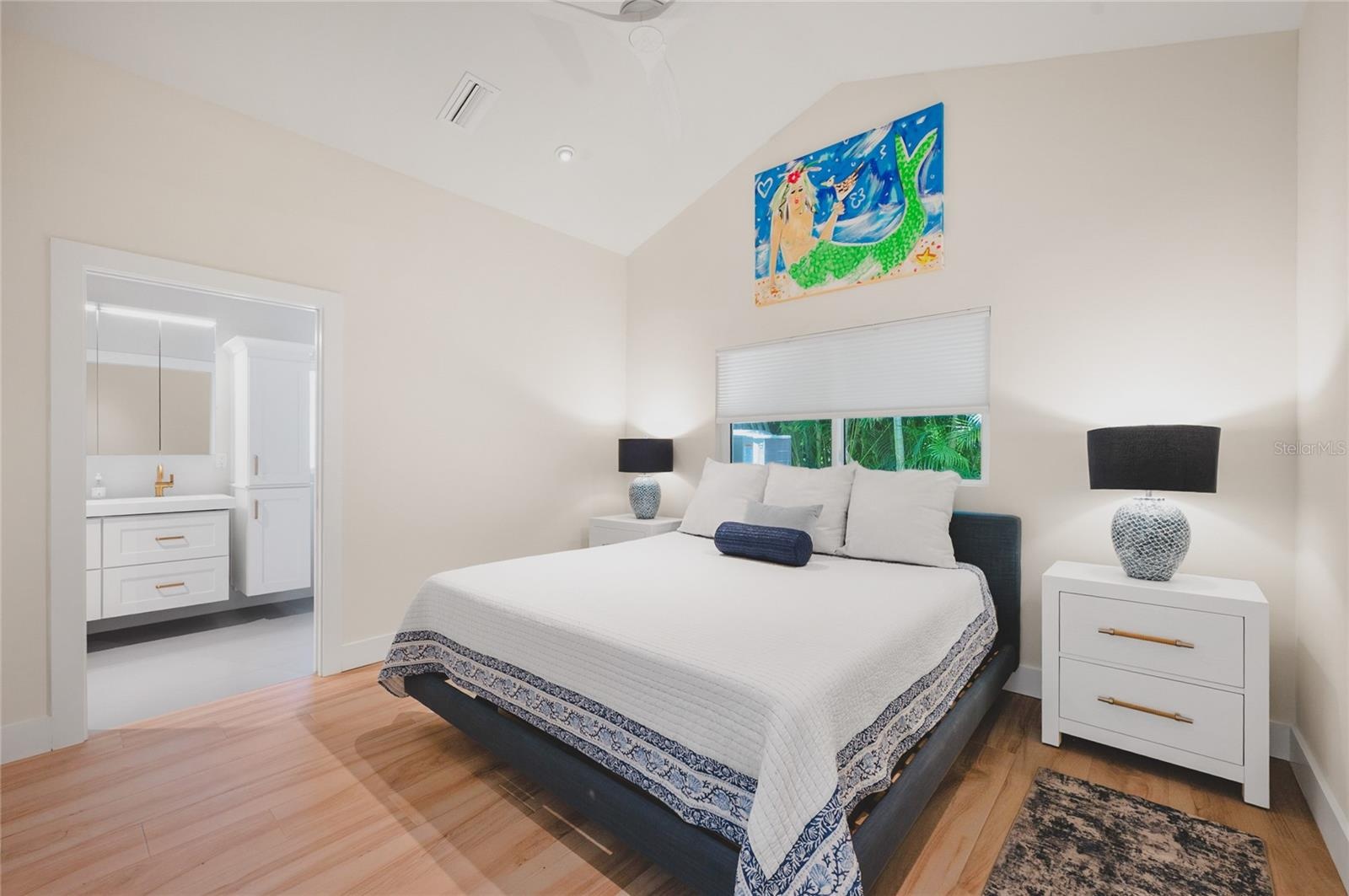 The primary suite has a king bed, custom artwork and ensuite bathroom
