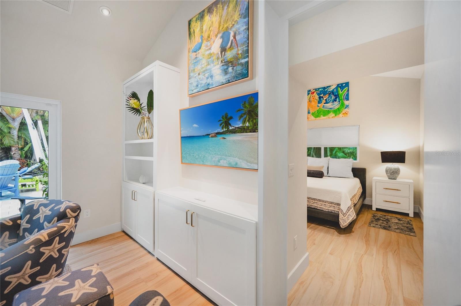 The primary suite is located just off the living room hidden behind a custom bookcase doorway