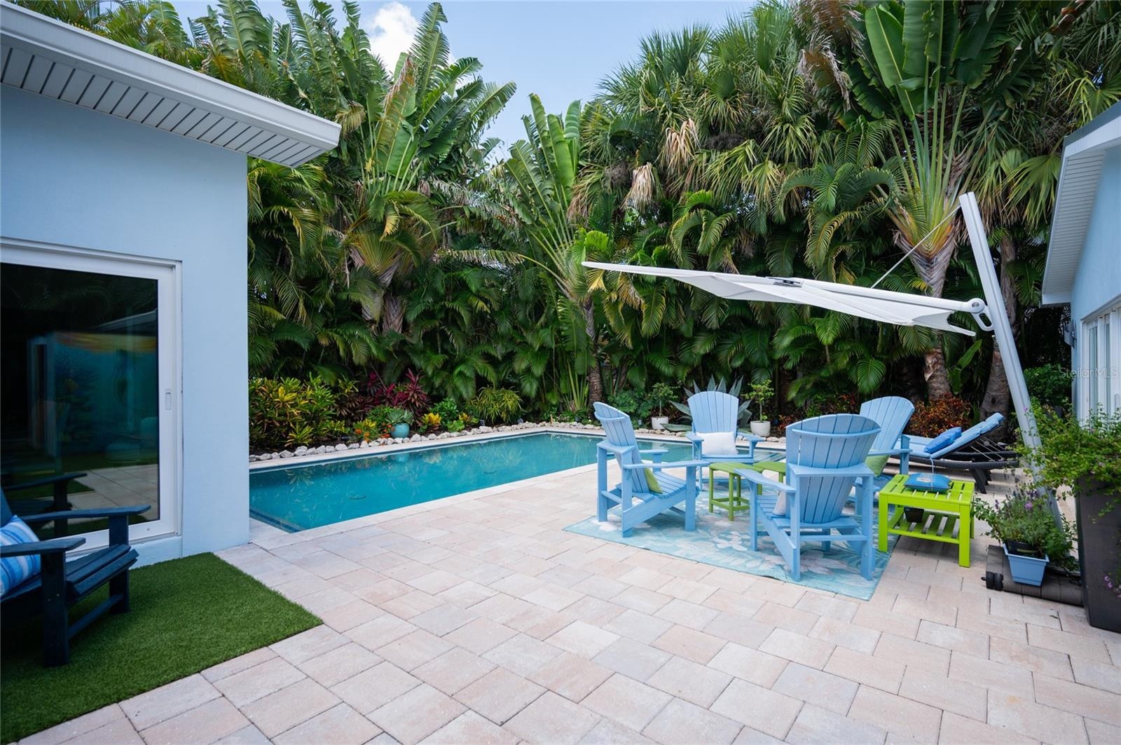 The patio area features pavers and turf