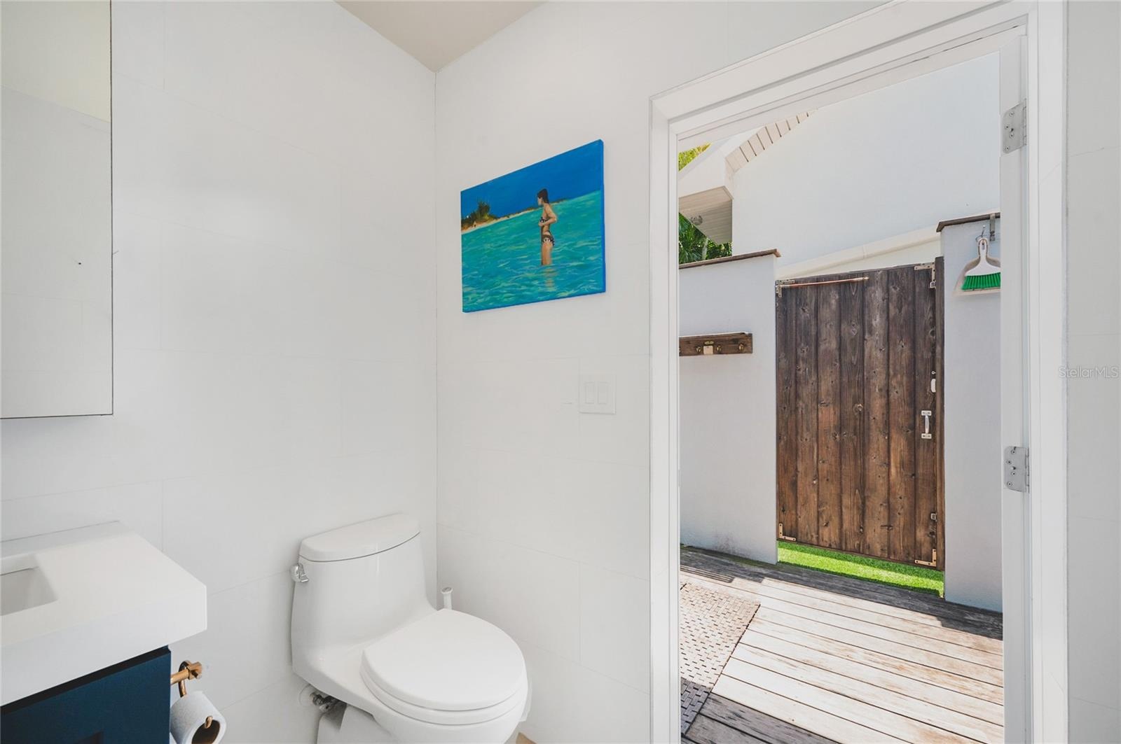 The Casita half bath has a doorway that leads to the outside shower with has both hot and cold water.
