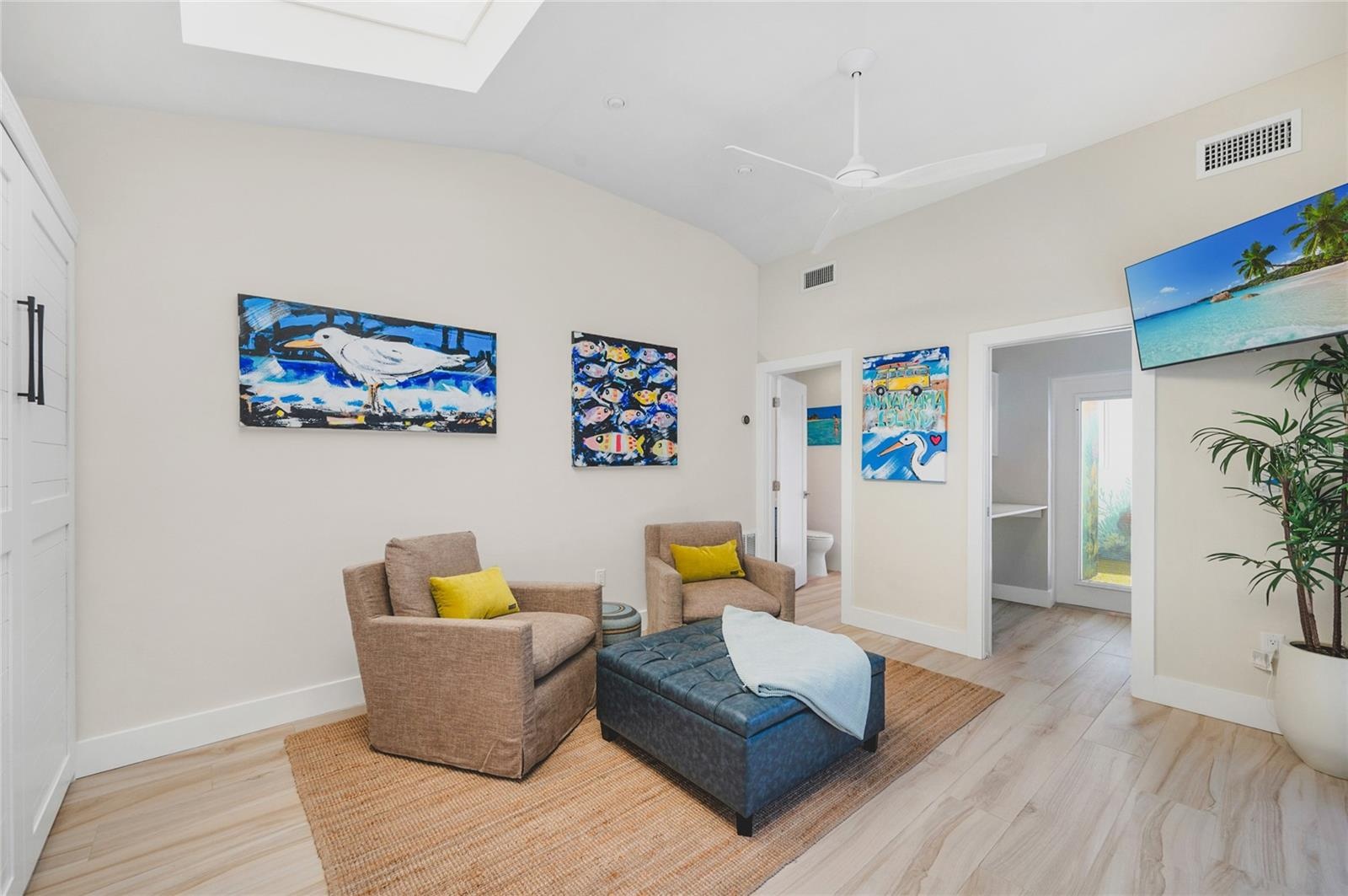 The Casita featuring the sitting area, TV and doorway to the half bath