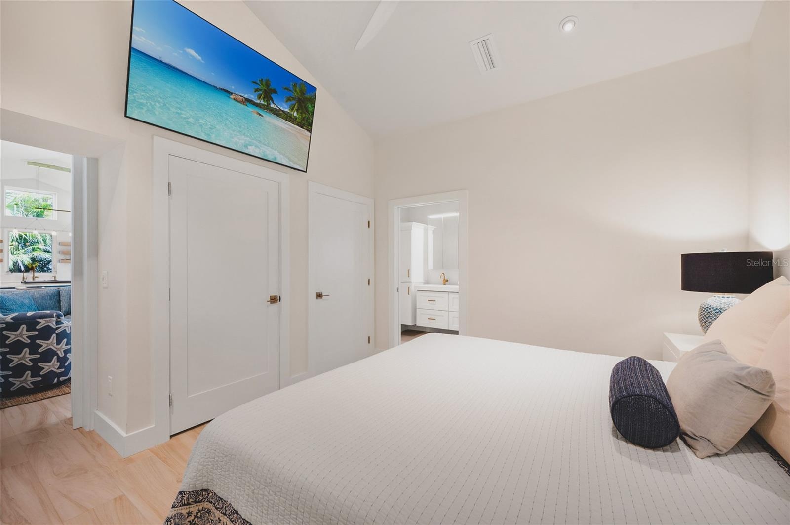 Primary bedroom with double closets and large screen TV