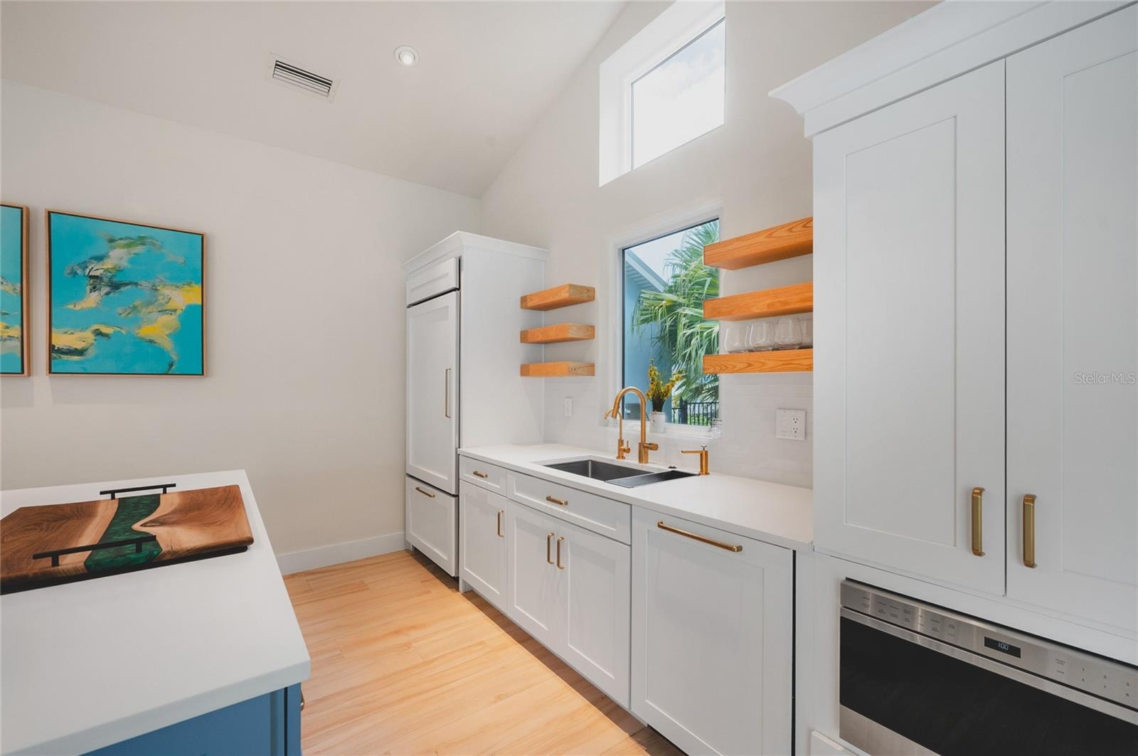 The kitchen boasts high end custom cabinetry and appliances