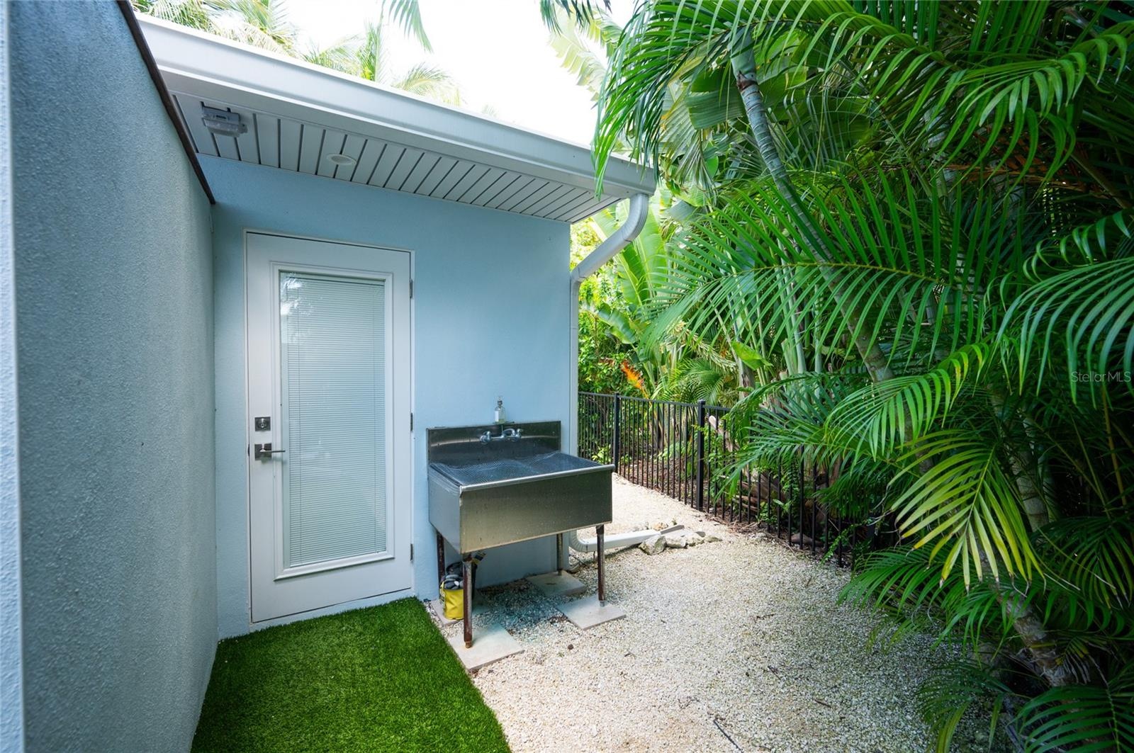 Casita building doorway to the laundry room and also features an outside wash basin