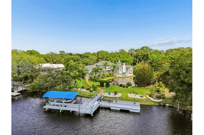Gulf Access with a private pond. Over 150ft on NEW seawall. 10,000 lb boat lift. Still dock and floating dock.