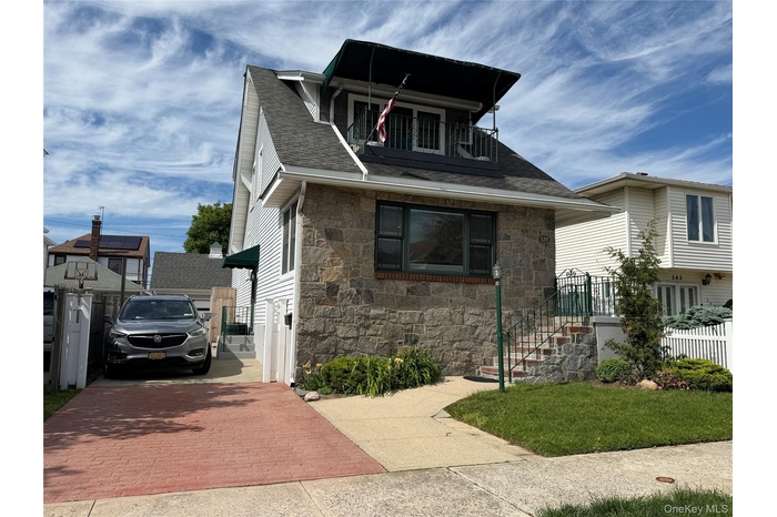 Extended driveway with 2 -car garage. Front deck.