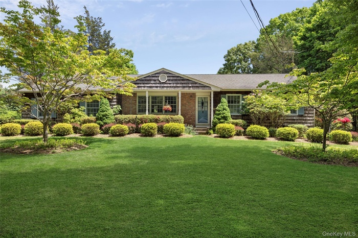 Front of the home located around the corner from Cedar Beach sitting on just shy of an acre.
