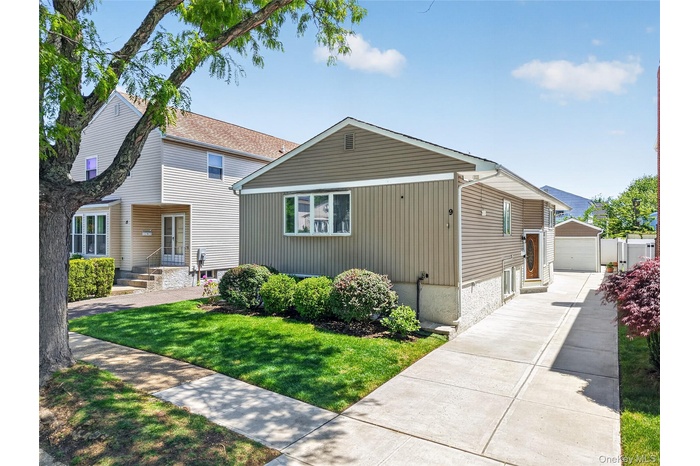 Garage w/Long Driveway & newer concrete slab can accomodate an additional 4 cars.