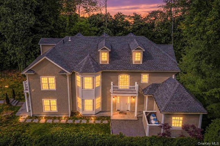 Grand residential exterior featuring multiple gables, dormer windows, and a prominent bay window
