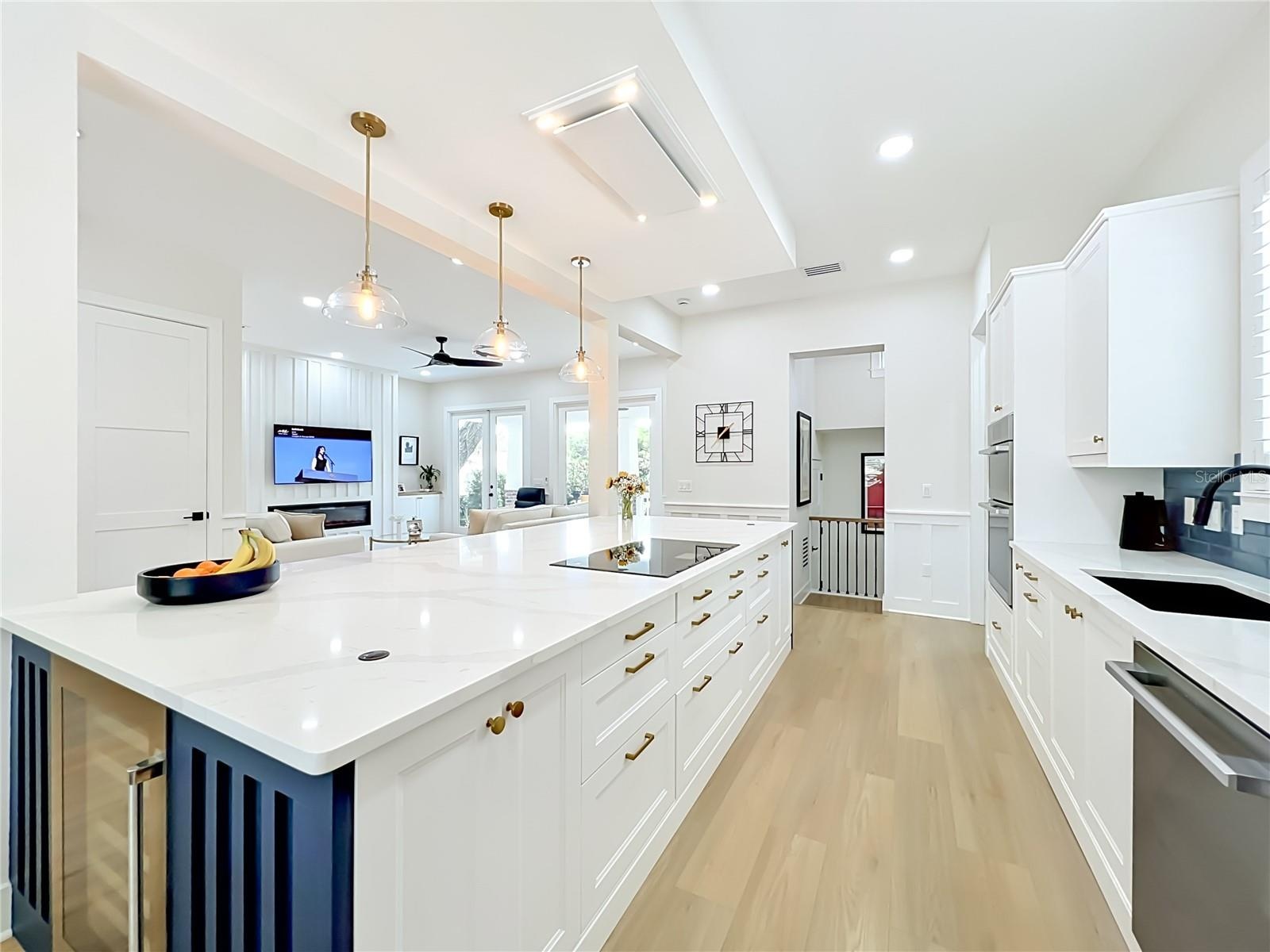 Island with cupboards on each side and wine fridge