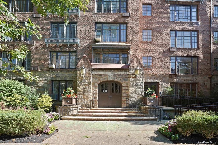 Stone and brick facade building with a prominent arched stone entryway