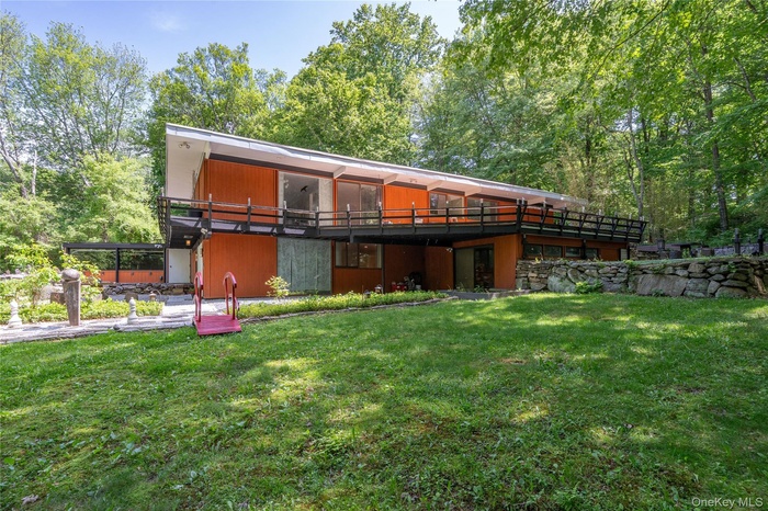 Privately nestled on 1.2 serene acres, this striking mid century modern home offers tranquil wooded surroundings, dramatic architectural lines, expans