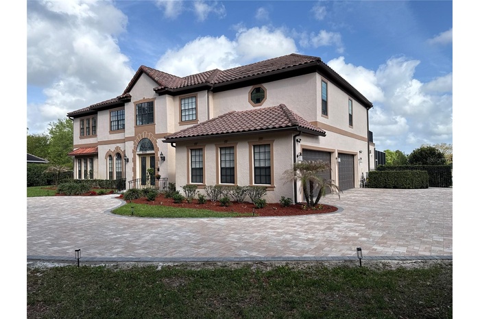 Welcome Home! Gorgeous mediterranean style estate set on almost 3/4 acre. Custom circular paver driveway with fountain.