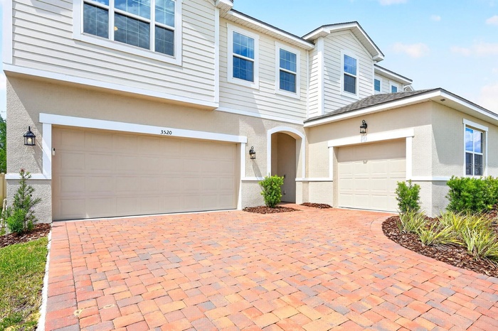 From the moment you arrive, the home impresses with its paver driveway, COURTYARD-STYLE 3-CAR GARAGE, and attractive curb appeal.