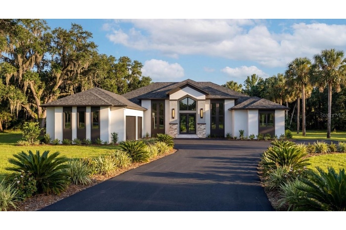 Home is set back in the lot, nestled in 1.5 acres
