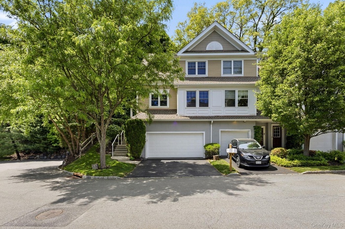 Front view of 94 Hillcrest, a desirable end-unit residence on the left featuring a spacious 2-car garage.