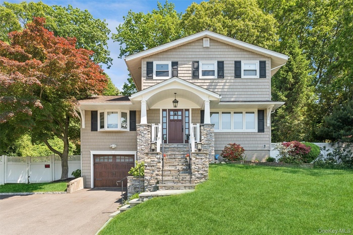 Stunning curb appeal with custom stacked stone, portico and slate steps