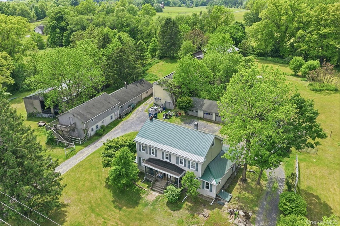 Terrific Value on 5+ acres with Colonial Home and 4 outbuildings.