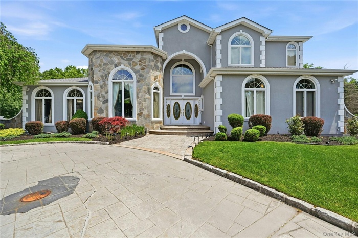 Stucco exterior with stone veneer accents and arched windows