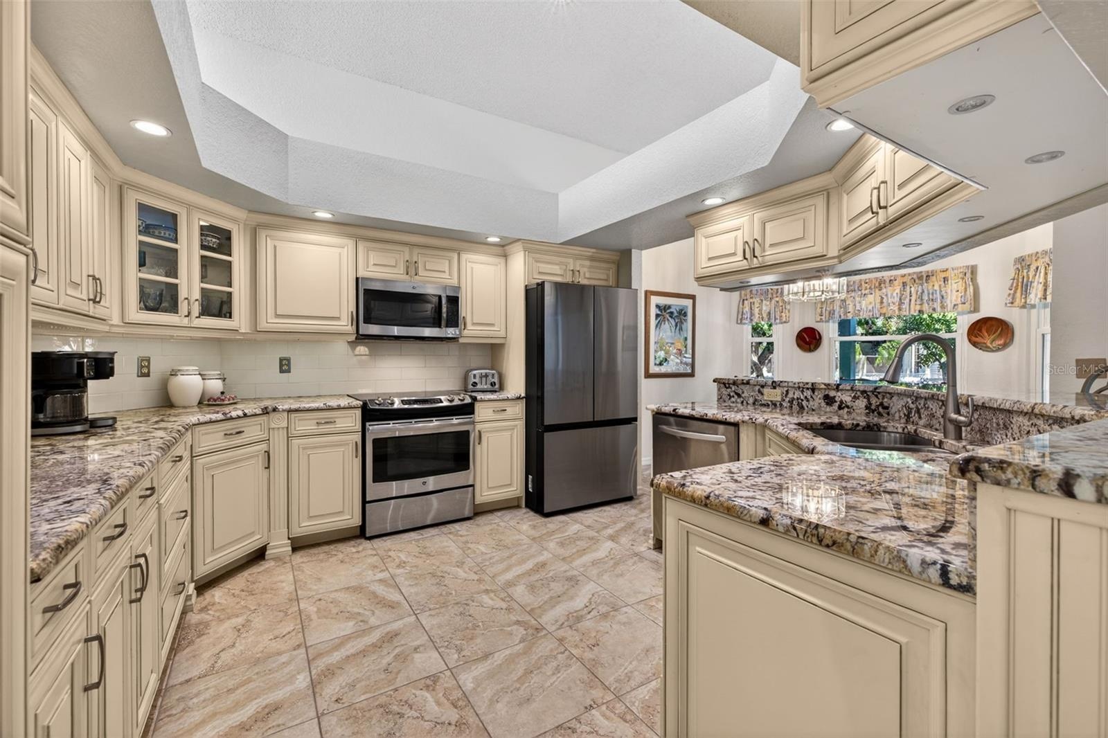 Beautifully updated kitchen with furniture grade cabinetry, granite countertops, stainless appliances, and loads of under cabinet lighting